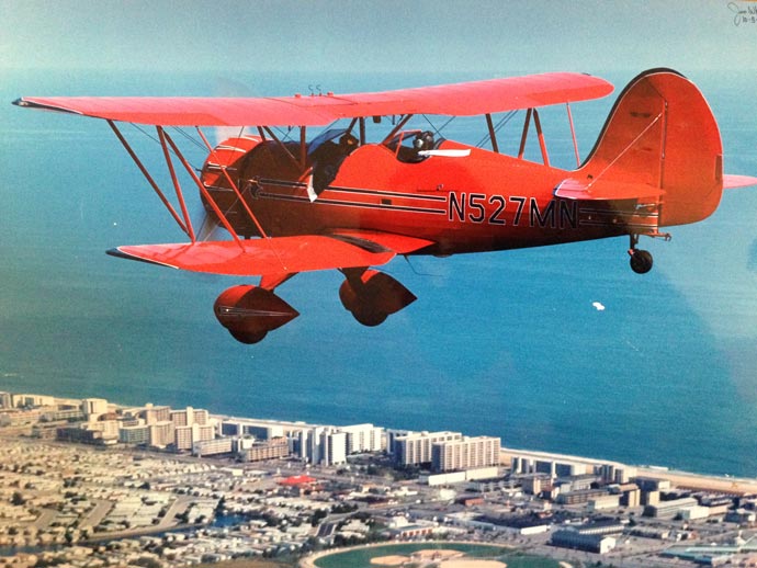 red small plane flying over ocean city maryland